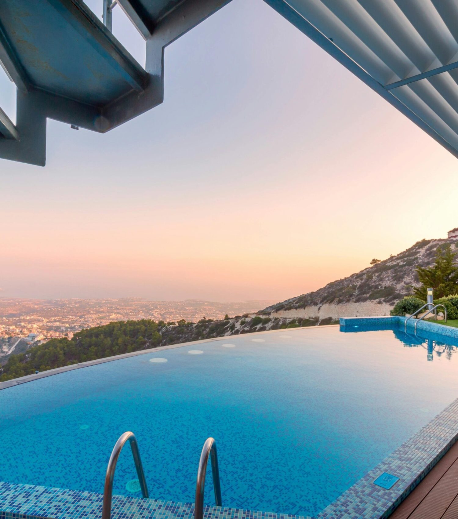 Infinity pool with breathtaking mountain and city views, perfect for a luxury tropical getaway.